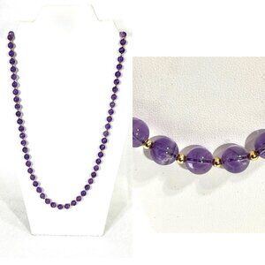 Continuous necklace of amethyst and gold-tone beads.